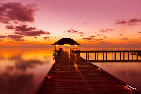 Water cafe at sunset - Maldives vacation backgroundのeditorial素材