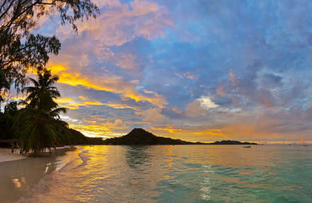 Tropical beach Cote d'Or at Seychelles on sunset - vacation backgroundの写真素材