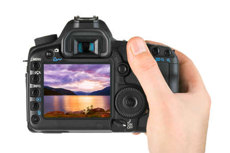 Hand with camera and Norway travel photo isolated on white background
