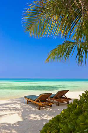 Loungers on Maldives beach - nature vacation backgroundの写真素材