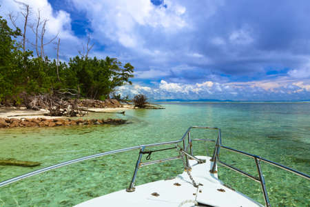 Tropical island and boat on Seychelles - vacation backgroundの写真素材