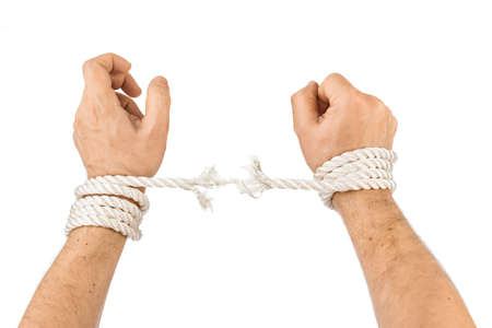 Hands and breaking rope isolated on white backgroundの写真素材