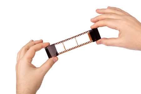 Photographic film in hands isolated on white backgroundの写真素材