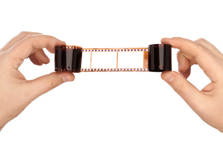Photographic film in hands isolated on white backgroundの写真素材