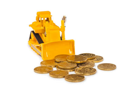 Toy bulldozer and money coins isolated on white backgroundの写真素材