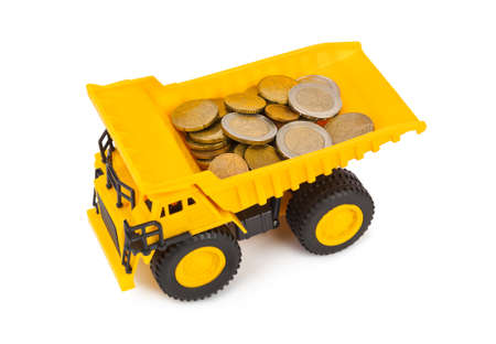 Toy car truck with money coins isolated on white backgroundの写真素材