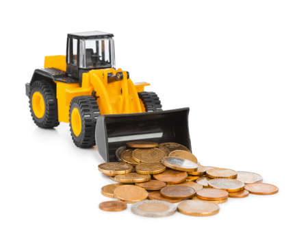Toy loader and money coins isolated on white backgroundの写真素材