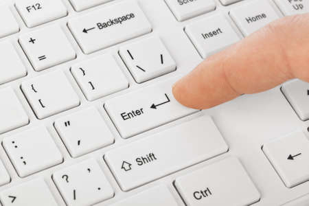White computer keyboard and hand - technology backgroundの写真素材