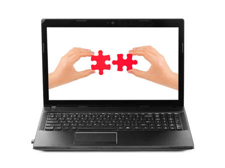Hands and puzzle in computer - isolated on white background