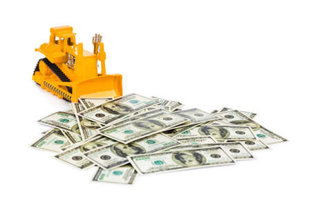 Toy bulldozer and money isolated on white backgroundの写真素材