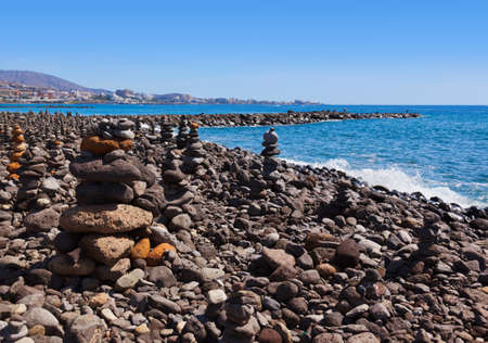 Stack of stones on beach in Tenerife island - Canary Spain