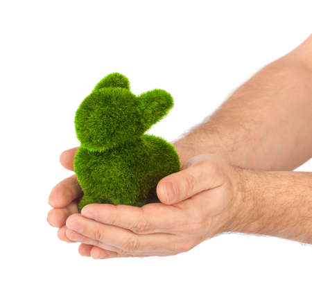 Rabbit made of grass in hands isolated on white backgroundの写真素材