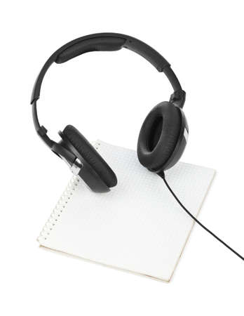 Headphones and notepad isolated on white backgroundの写真素材