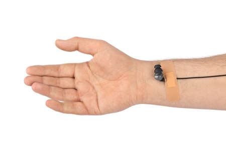 Hand with earphones like medical IV infusion isolated on white background