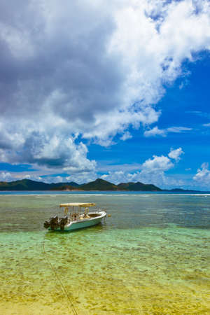 Tropical island at Seychelles and boatの写真素材