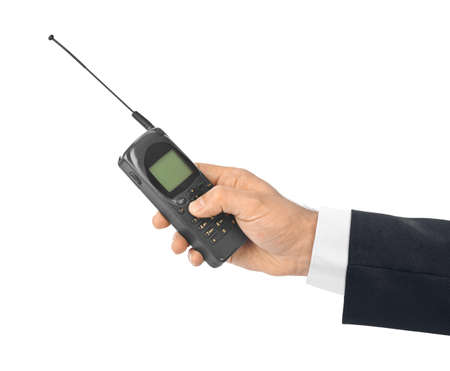 Hand with retro mobile phone isolated on white background