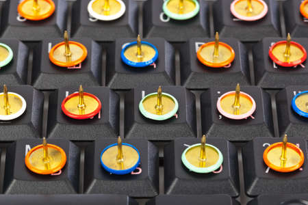 Pins on computer keyboard - concept background