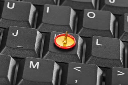 Pin on computer keyboard - concept background