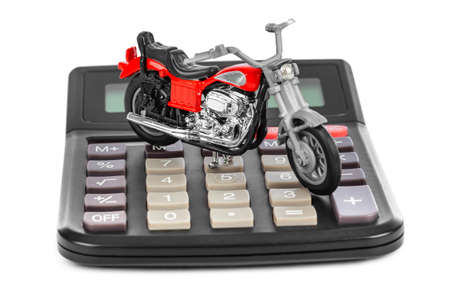 Calculator and toy motorbike isolated on white backgroundの写真素材