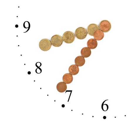 Clock made of money coins isolated on white backgroundの写真素材