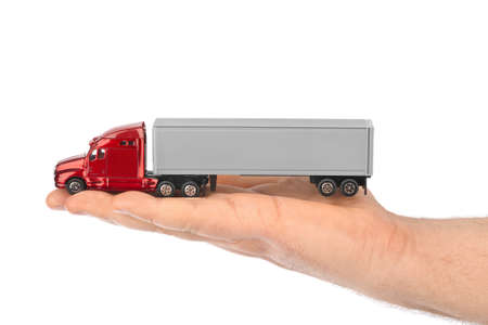 Toy car truck in hand isolated on white backgroundの写真素材