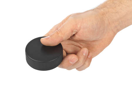 Hand with hockey puck isolated on white background
