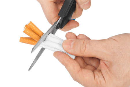 Hand with scissors and cigarettes isolated on white background