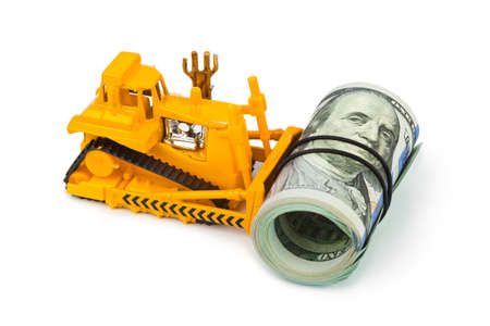 Toy bulldozer and money isolated on white backgroundの写真素材