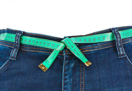 Jeans and measuring tape - slimming concept - isolated on white backgroundの写真素材