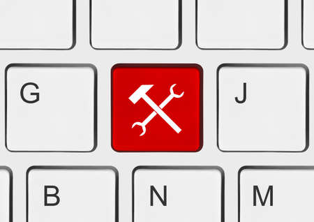 Computer keyboard with tools key - technology backgroundの写真素材