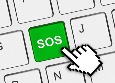 Computer keyboard with SOS key - technology backgroundの写真素材