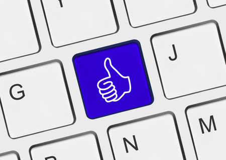 Computer keyboard with thumb gesturing hand keyの写真素材