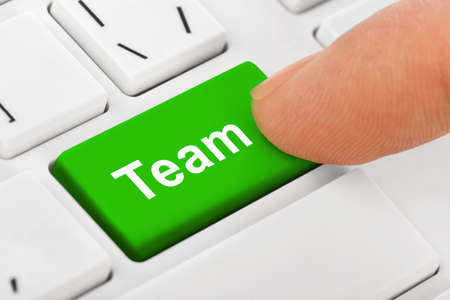 Computer notebook keyboard with Team key - technology background