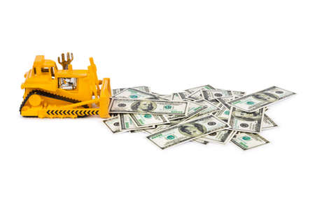 Toy bulldozer and money isolated on white backgroundの写真素材