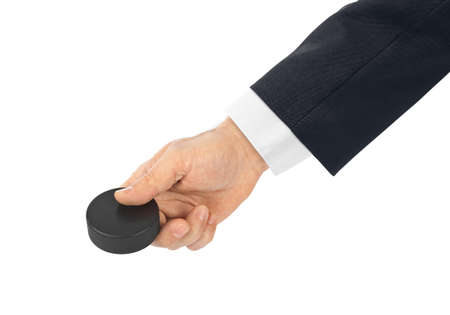 Hand with hockey puck isolated on white background