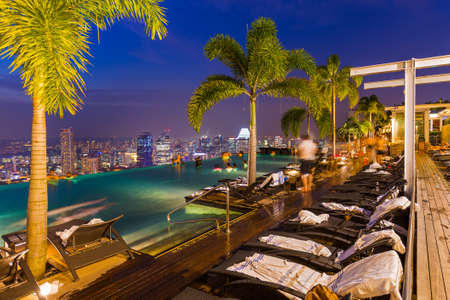 Pool on roof and Singapore city skylineのeditorial素材