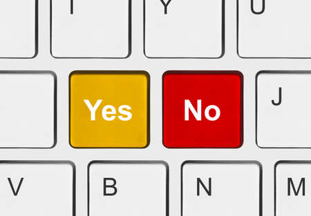 Computer keyboard with Yes and No keys - business conceptの写真素材