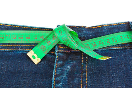 Jeans and measuring tape - slimming concept - isolated on white backgroundの写真素材