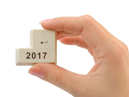 Computer button 2017 in hand isolated on white backgroundの写真素材