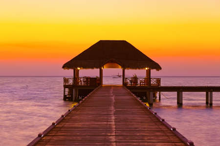 Water cafe at sunset - Maldives vacation backgroundの写真素材