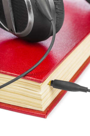 Headphones and book isolated on white backgroundの写真素材