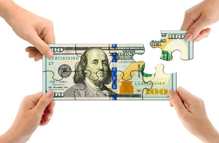 Hands and money puzzle isolated on white backgroundの写真素材