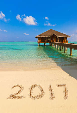 Numbers 2017 on beach - concept holiday background