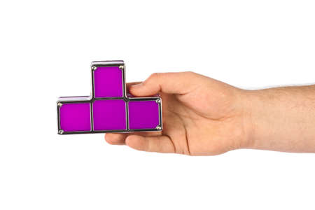 Hand with tetris toy blocks isolated on white backgroundの写真素材