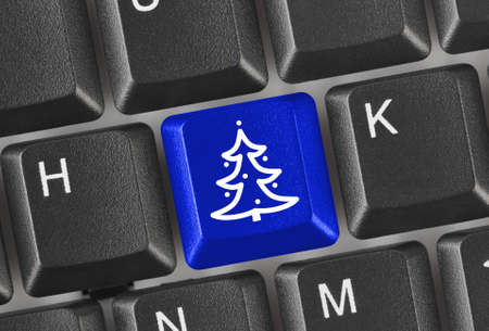 Computer keyboard with Christmas tree key - holiday conceptの写真素材