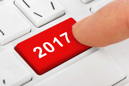 Computer notebook keyboard with 2017 key - holiday technology concept