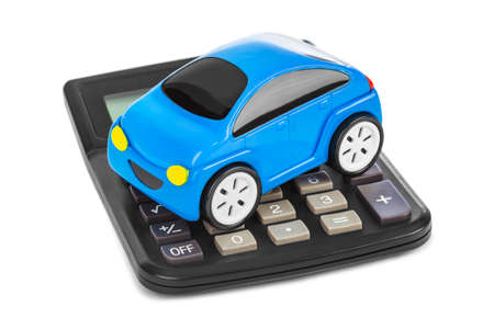 Calculator and toy car isolated on white backgroundの写真素材