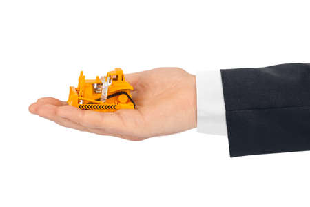 Hand with toy bulldozer isolated on white backgroundの写真素材
