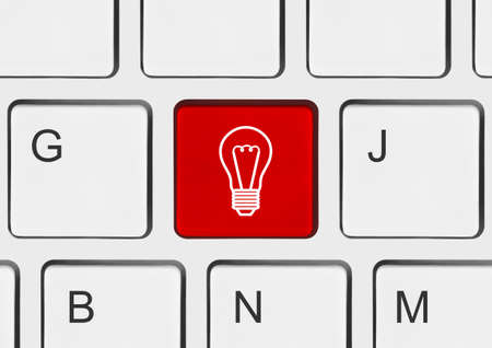 Computer keyboard with lamp key - technology backgroundの写真素材