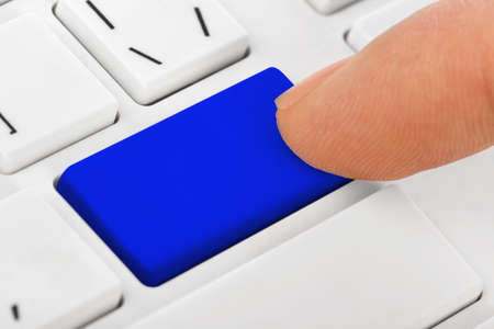 Computer notebook keyboard with blank blue key - technology backgroundの写真素材